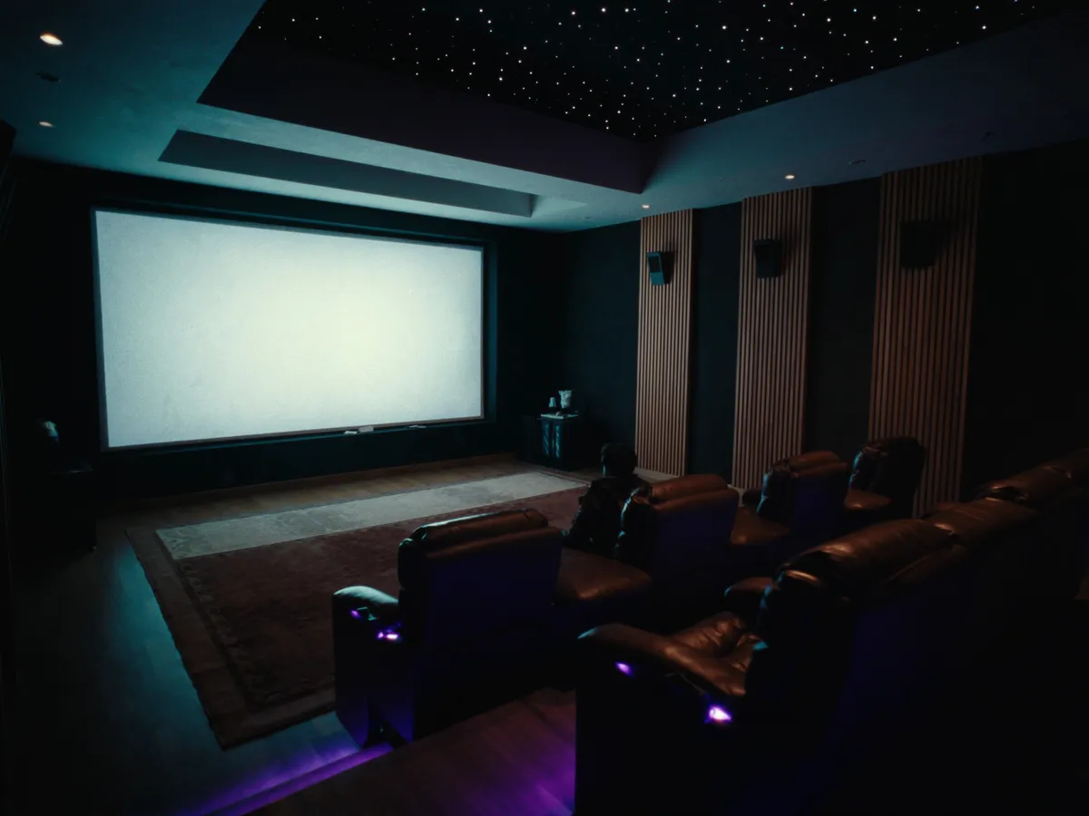 Luxury basement renovation in Kleinburg, Vaughan — tiered home theater with walnut acoustic panels and starlit ceiling