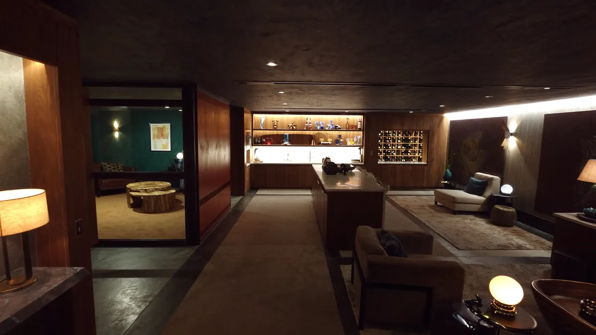 Finished luxury basement with lounge seating and layered lighting